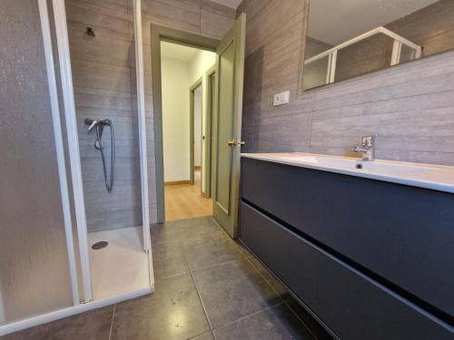 a bathroom with a sink and a shower at Apartamento céntrico Llanes in Llanes
