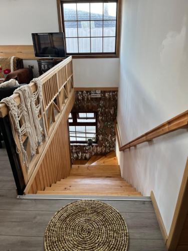a staircase in a house with a rug at ARCA HOTEL BOUTIQUE in Achao