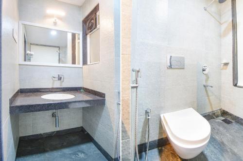a bathroom with a toilet and a sink and a mirror at Kantara Hotel By BIL in Lonavala