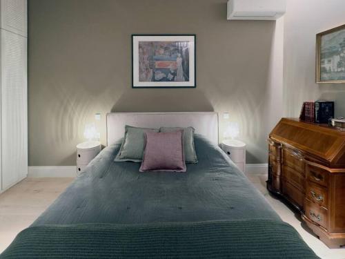 a bedroom with a large bed and a wooden dresser at Aphrodite's Hideaway in Athens