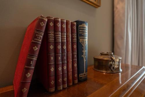 a group of books sitting on a table at Aphrodite's Hideaway in Athens