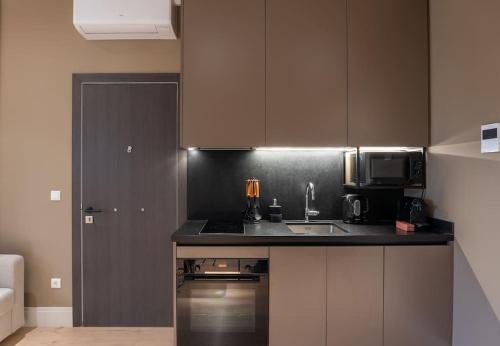 a kitchen with a sink and a microwave at Aphrodite's Hideaway in Athens
