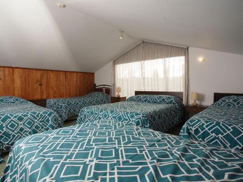 a hotel room with two beds and a window at Sandy Point B&B in Punta Arenas