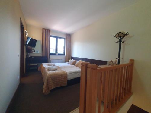 a hotel room with a bed and a window at Apartment ZAX B7 in Terra Complex in Bansko