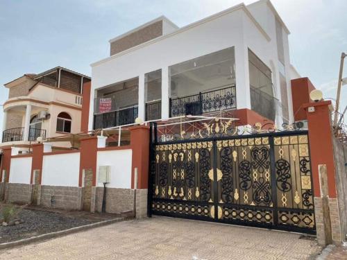a house with a gate in front of it at IDMAN RESIDENCE in Ambouli