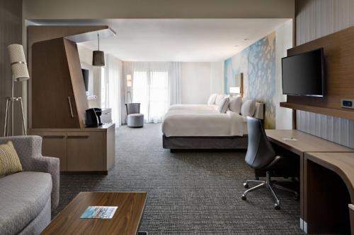 a large hotel room with a bed and a desk at Courtyard by Marriott Houston Northwest/Cypress in Cypress