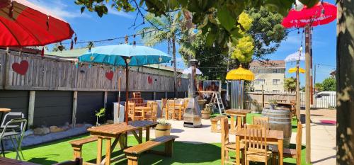 a patio with tables and chairs and an umbrella at Chai & Spice Guesthouse and Café in George