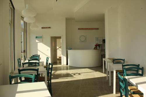 a dining room with tables and chairs and a counter at B&B Alalama in Polignano a Mare