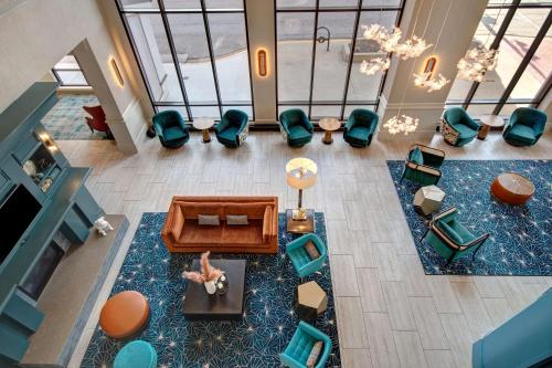 an overhead view of a living room with green chairs at Hilton Garden Inn Terre Haute in Terre Haute