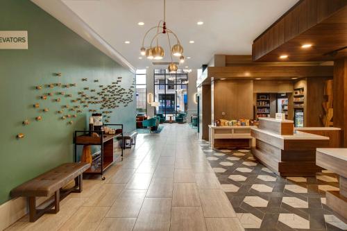 a lobby of a store with a bench at Hilton Garden Inn Terre Haute in Terre Haute