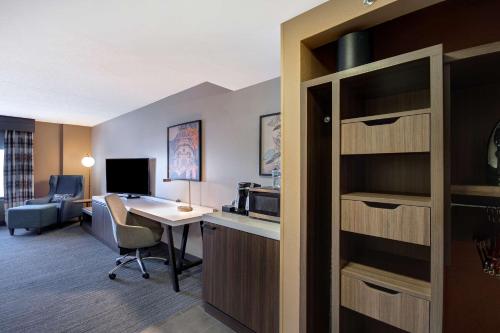 a hotel room with a desk and a computer in a room at Hilton Garden Inn Terre Haute in Terre Haute