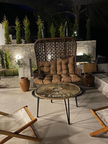a couch sitting on a patio with a coffee table at Damari Luxury Retreat Villas Skiathos in Skiathos Town
