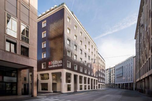 an empty street in a city with tall buildings at Hilton Garden Inn Padova City Centre in Padova