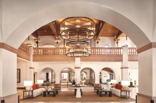 a large lobby with a large archway and chandeliers at Zachari Dunes on Mandalay Beach, Curio Collection by Hilton in Oxnard