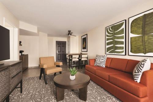 a living room with a couch and a table at Zachari Dunes on Mandalay Beach, Curio Collection by Hilton in Oxnard