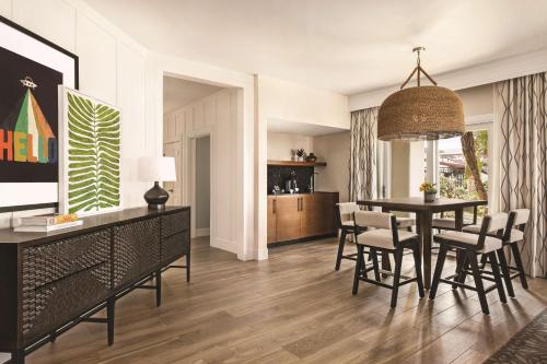 a living room with a dining room table and chairs at Zachari Dunes on Mandalay Beach, Curio Collection by Hilton in Oxnard