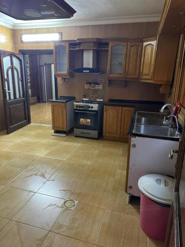 a kitchen with a sink and a stove top oven at شقه فخمه مفروشه بالكامل في اربد in Irbid