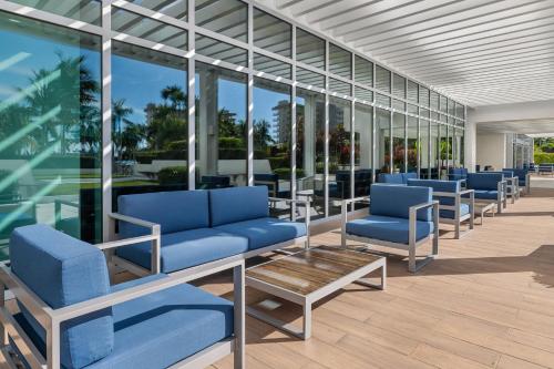 a row of blue chairs in a building with windows at Marriott's Crystal Shores in Marco Island