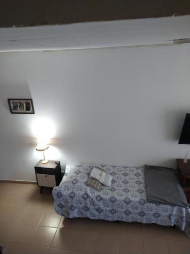 a bedroom with a bed and a table with a lamp at Duplex Playa Unión in Playa Unión