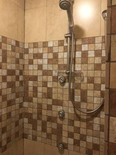a shower in a bathroom with a tiled wall at Beautiful and Peaceful Home in Halifax