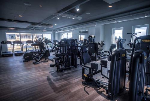 a gym with lots of treadmills and elliptical machines at The Lake - Casa Vacanza in Dormelletto