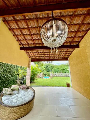 a large chandelier hanging from a wooden ceiling at Espaço Vitória Imperial in Guapimirim