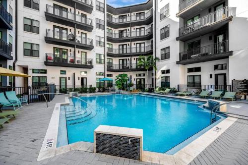 a swimming pool in front of a apartment building at Luxury Stylish Apt in Historic Ybor City in Tampa