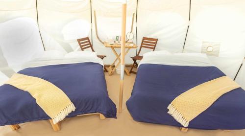 a room with two beds in a tent at Hôtel UNIQ - Domaine Saint-Bernard in Mont-Tremblant