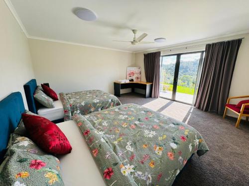 pokój hotelowy z 2 łóżkami i kanapą w obiekcie Luxury Modern 3-BDR Oasis w mieście Kumeu