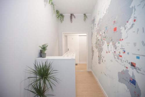 a white room with a map of the world on the wall at Aerostay Hostel in Moreira