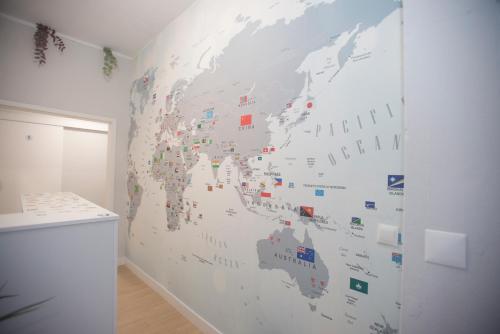 a wall with a map of the world on it at Aerostay Hostel in Moreira