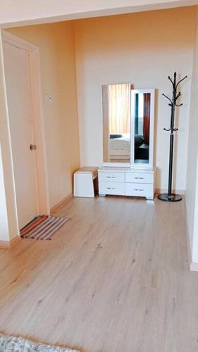 a living room with a tv and a wooden floor at Silverpart Resort Fraser Hill C3-6-2 Forest View High Floor No lift in Bukit Fraser