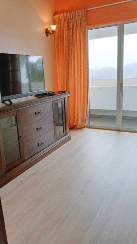 a living room with a flat screen tv on a dresser at Silverpart Resort Fraser Hill C3-6-2 Forest View High Floor No lift in Bukit Fraser