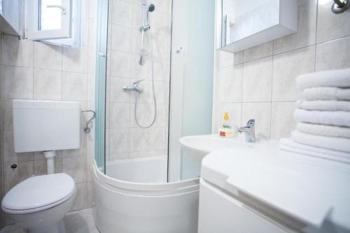 a bathroom with a shower and a toilet and a sink at Holiday house with a parking space Zrnovnica, Split - 22688 in Žrnovnica
