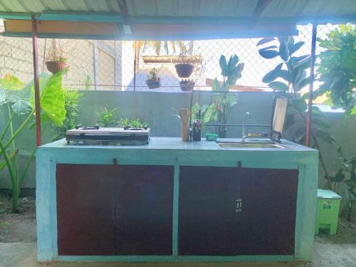 a outdoor kitchen with a sink and a counter at Selim Guesthouse in San Vicente