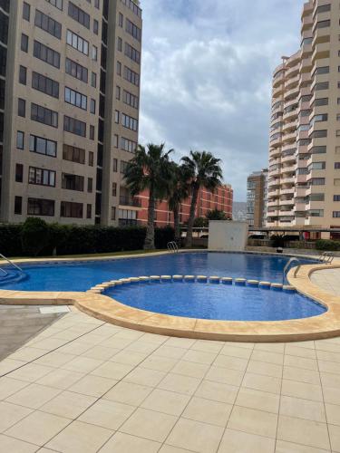 a large swimming pool in a city with tall buildings at Apartment Bahia del Sol, a 20 m de Playa Arinal-Bol,Calpe in Calpe