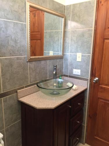 a bathroom with a sink and a mirror at Casa Playa Bahia Ballena de Osa in Uvita