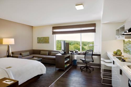 a hotel room with a bed and a kitchen at Element Lexington in Lexington