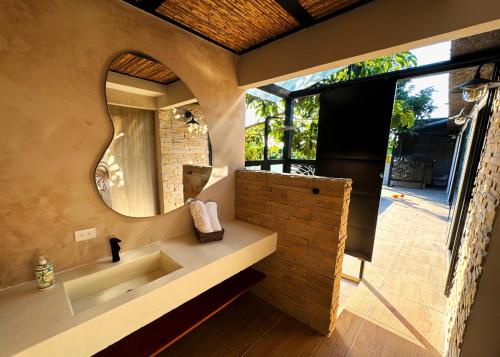 ein Bad mit einem Waschbecken und einem Spiegel in der Unterkunft Casa Toronja in Montenegro