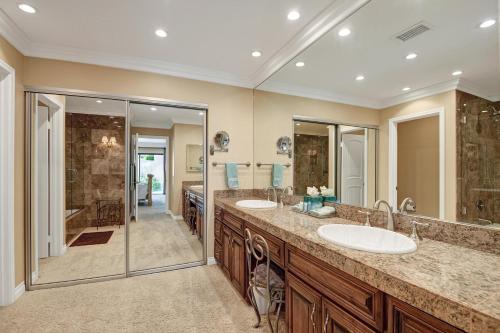 a bathroom with two sinks and a shower at VB944 - Triple Fairway View - Palm Valley CC in Palm Desert