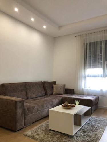 a living room with a couch and a coffee table at Apartment TAJM in Trebinje