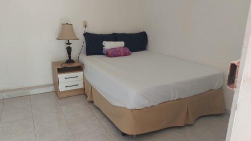 a bedroom with a bed and a lamp on a night stand at Alojamientos Santa Marta La Unión in La Unión