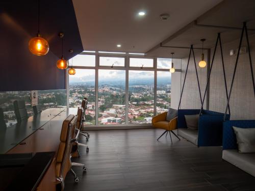 a living room with a view of a city at iFreses, Study Full equipped whith Pool, air- conditioning, spectacular view of the city, parking with additional payment in Curridabat