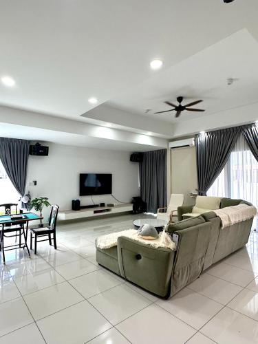 a living room with a couch and a tv at Peak Homestay@Ipoh Perak Malaysia 10-14Pax 5R/6B in Lahat