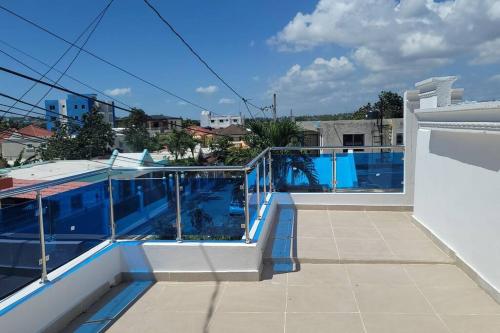 a balcony with a view of a swimming pool at Splendid 3 Bedroom House with Terrace -Near Utesa in Santiago de los Caballeros