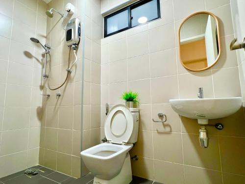 a bathroom with a toilet and a sink at Legoland-8min walk at Kairos Comfort Spacious Suite for Families 1-12pax in Nusajaya
