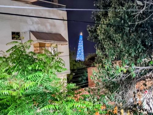 a blue christmas tree is projected on the side of a building at Apartamento Cerca al Faro y la Playa in Puerto Colombia