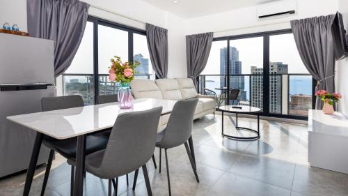 a kitchen and living room with a table and chairs at AIR Condominium & Residence - Sihanoukville - 5mn to boat pier in Sihanoukville