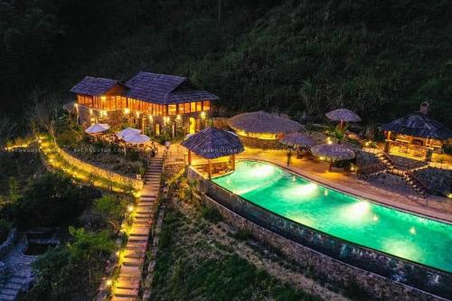 an aerial view of a house with a pool at night at Mường Lống Ecogarden 