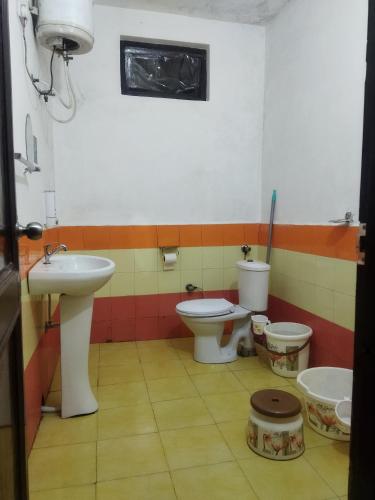 a bathroom with two toilets and a sink at Samarpan in Nainital